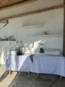 a table with a white table cloth on it at Pargo, habitación privada de Flor de Lis Beach House in Playas