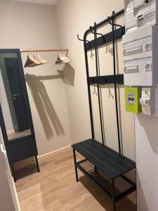 a black chair in a room with a mirror at Le Col Getaway Virage 6 in Le Bourg-dʼOisans