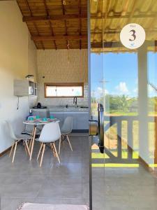 a kitchen and dining room with a table and chairs at Via Del Mare Flats in Marau