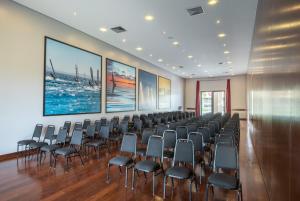 a large room with chairs and paintings on the walls at Vila Galé Resort Cumbuco - All inclusive in Cumbuco +208 photos
