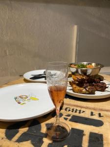a glass of beer sitting on a table with plates of food at Pousada Nosso Sonho in Natal