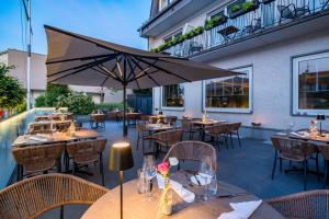 a restaurant with tables and chairs and an umbrella at Landgasthof Eiserner Ritter in Boppard