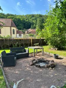 a patio with a table and couches in a yard at Familienparadies Bousseviller in Bousseviller