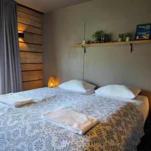 a bedroom with a bed with two towels on it at Akureyri Hostel in Akureyri