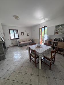 a kitchen and living room with a table and chairs at Anza Village - Ds Hüüsji 1 in Vanzone +5 photos