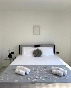 a bedroom with a bed with two towels on it at Raba Apartments in Donji Štoj