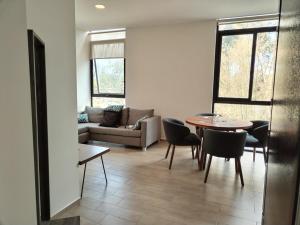 a living room with a table and a couch at Relax at the lake - Pool - Pet friendly - WiFi in Chantepec
