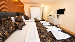 a hotel room with a bed with towels on it at Olive Branch Hotel in Ayvalık