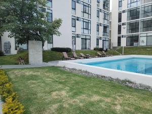 a swimming pool in front of a building at Relax at the lake - Pool - Pet friendly - WiFi in Chantepec