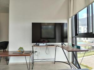 a room with two desks and a tv on a wall at Relax at the lake - Pool - Pet friendly - WiFi in Chantepec