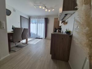 a kitchen with a table and chairs in a room at Helle Wohnung im schönen Allgäu in Kraftisried +5 photos