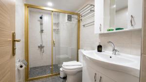 a bathroom with a shower and a sink and a toilet at Olive Branch Hotel in Ayvalık +32 photos