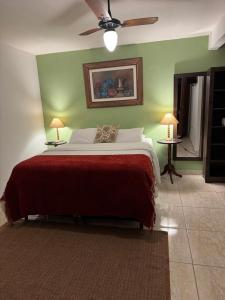 a bedroom with a bed and two tables with lamps at Pousada Belvedere da Serra in Serra do Cipo +152 photos