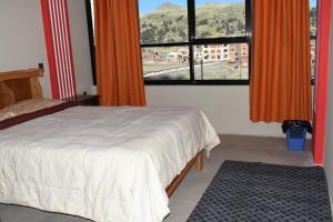 a bedroom with a bed and a large window at Nexus Hotel & Coworking in Copacabana