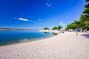 a person walking on a beach near the water at Villa Meja in Hreljin