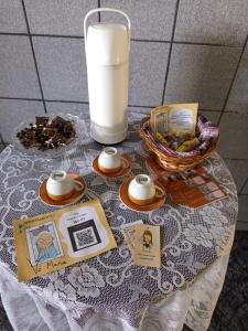 a table with a glass of milk and a basket of food at Apartamento Vó Maria in Triunfo