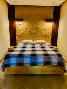 a bedroom with a bed with a checkered blanket at Emerald flat in Marsa Alam City