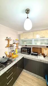a kitchen with a counter with a stove top oven at Surf house apartment in Oualidia