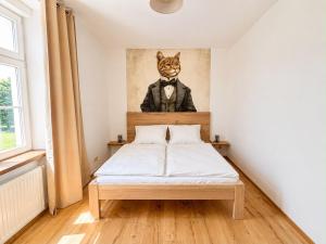 a bedroom with a bed with a cat in a suit at Casa Roberto, Apartment 2 in Mariazell
