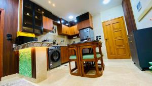 a kitchen with a table and a washing machine at Emerald flat in Marsa Alam City +10 photos