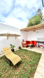 a patio with a bench and a table and a grill at Surf house apartment in Oualidia
