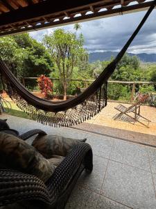 a hammock on a patio with a view at Pousada Belvedere da Serra in Serra do Cipo