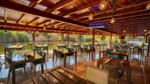 a restaurant with tables and chairs and a view of a river at Olive Branch Hotel in Ayvalık