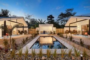 an exterior view of a house with a swimming pool at Villa Peuchere in Santa Cruz