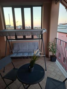 a balcony with a bed and a table and chairs at LOCAZIONE TURISTICA Camere De Vito in San Salvo +7 photos