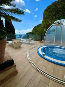 a hot tub on the deck of a house at Il Nido del Gabbiano in Vietri sul Mare