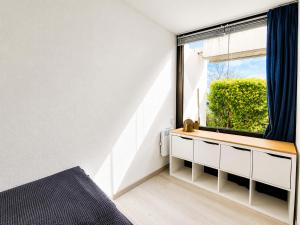 a bedroom with a window and a bed in it at Strandläufer in Wendtorf