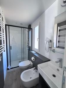a white bathroom with a toilet and a sink at Chalet - Snow Village Roccaraso in Roccaraso +23 photos