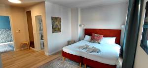 a bedroom with a bed with two shoes on it at Retreat Villa, Hot tub, BBQ in Lisbon +55 photos