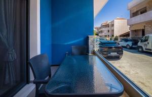 a blue table and chairs on a balcony at Aurelio Luxury Apartments in Paloúkia