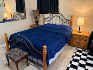 a bedroom with a bed with a blue comforter at EmERALD loft studio SWiMMiNG pool kitchen DwNTwN in Phoenix +25 photos