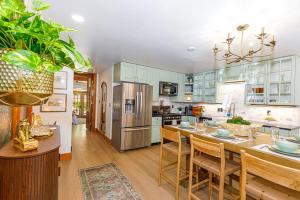 a kitchen with a table and chairs and a refrigerator at Harvest and Hearth in Galena
