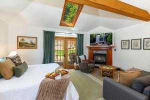 a living room with a bed and a fireplace at Harvest and Hearth in Galena