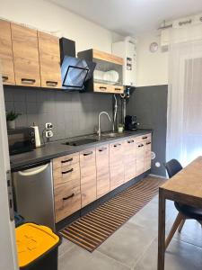 a kitchen with wooden cabinets and a sink at Via Roma Residence in Maniago +33 photos