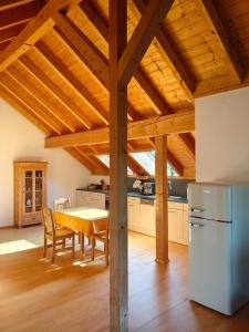a kitchen and dining room with a wooden ceiling at Chalet-Loft im Schwarzwaldhof Wutachblick in Bonndorf im Schwarzwald