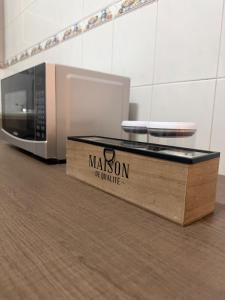 a wooden box on the floor next to a microwave at casa granada en Carranza in San Luis Potosí +9 photos