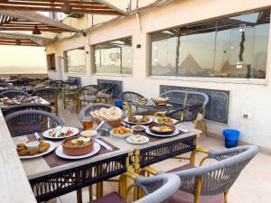 a table with food on it in a restaurant at Luxurious GEM and PYRAMIDS view in Cairo