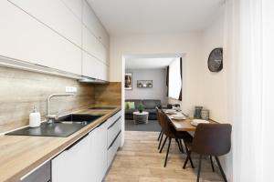 a kitchen with a table and a dining room at Apartmány Stožec - Nella Premium in Stožec