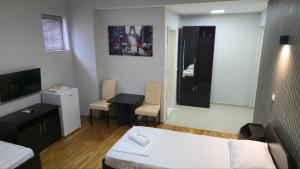 a bedroom with a bed and a table and a desk at Apartments Philip II in Ohrid +50 photos