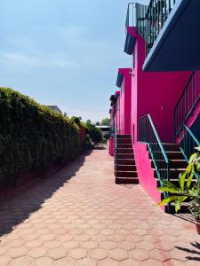 a pink building with stairs on the side of it at Habitación 11 Posada Itzel in Oaxaca City