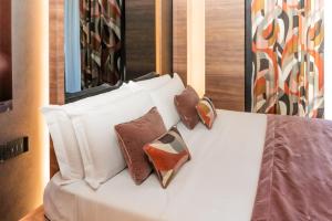 a white bed with four pillows on it at Hotel Orizzonte in Giugliano in Campania +78 photos