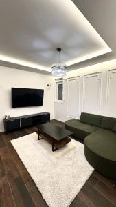 a living room with a green couch and a coffee table at Apartment Niko in Posušje
