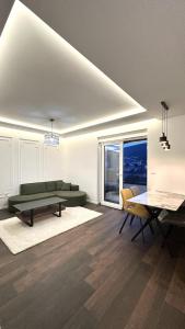 a living room with a green couch and a table at Apartment Niko in Posušje