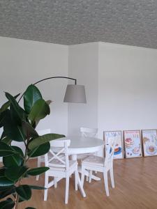 a white dining room with a white table and chairs at Det Gamla Postkontoret in Råda