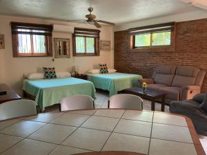 a living room with two beds and a couch at Brisa Suave Studio Suite in Punta Mita