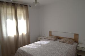 a bedroom with a bed and a large window at Montaña Tirba in Costa Calma